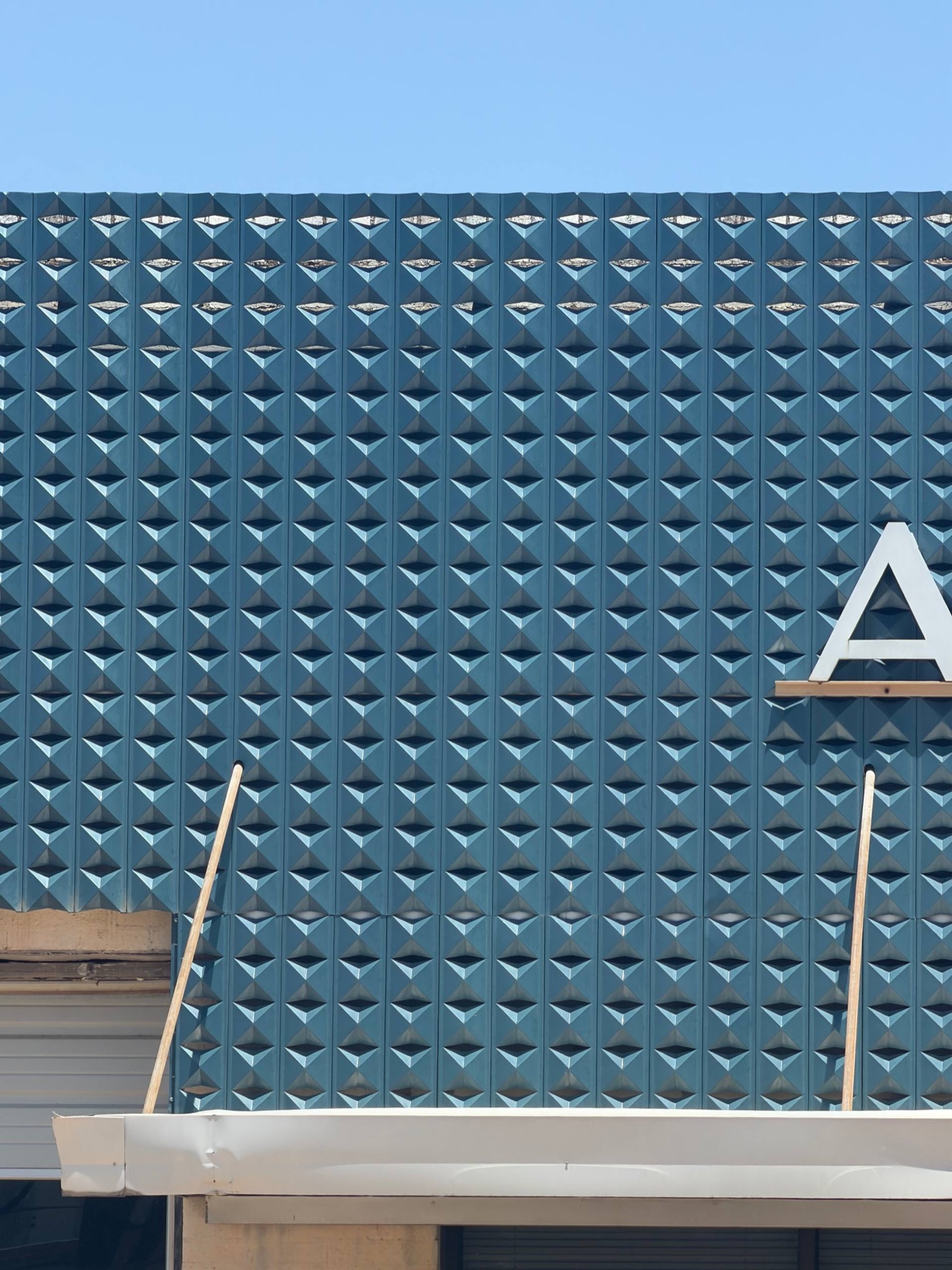 Blue diamond tile facade of the American Glass Co building